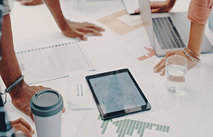 Employees at their desks learning what is resource forecasting on their computers